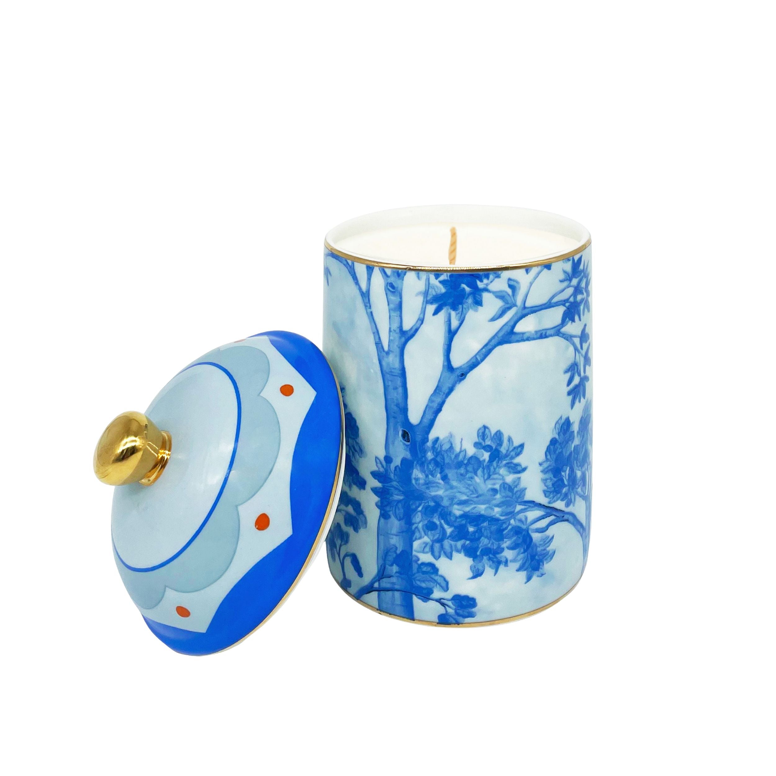 Kit Kemp Tall Trees blue and white ceramic candle with a floral pattern and a gold lid.
