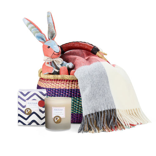 Rabbit patchwork toy, Checkerberry throw, and Lavender Eucalyptus candle in a hand woven basket created by Shop Kit Kemp for festive gifting and Christmas presents.
