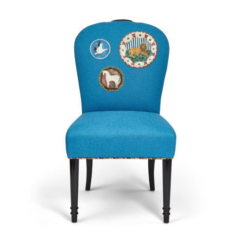 Blue chair with embroidered designs on a white background