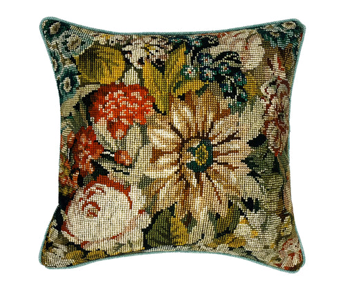 This image shows the front of the vintage needlepoint print cushion with a detailed, floral needlepoint design. The design features a variety of flowers in different colors, such as orange, white, and shades of yellow and green, set against a darker background that enhances the vibrant colors of the flowers.