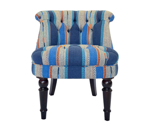 Kit Kemp's Stuart Chair in Bunty, part of Kit's new collaboration with GP& J Baker, is a gorgeously deep upholstered button back tub chair, which combined with Bunty's richly woven and embroidered stripe detailing in shades of blue, with orange arrow heads embroidery, forms a chair sumptuous in both comfort and colour.