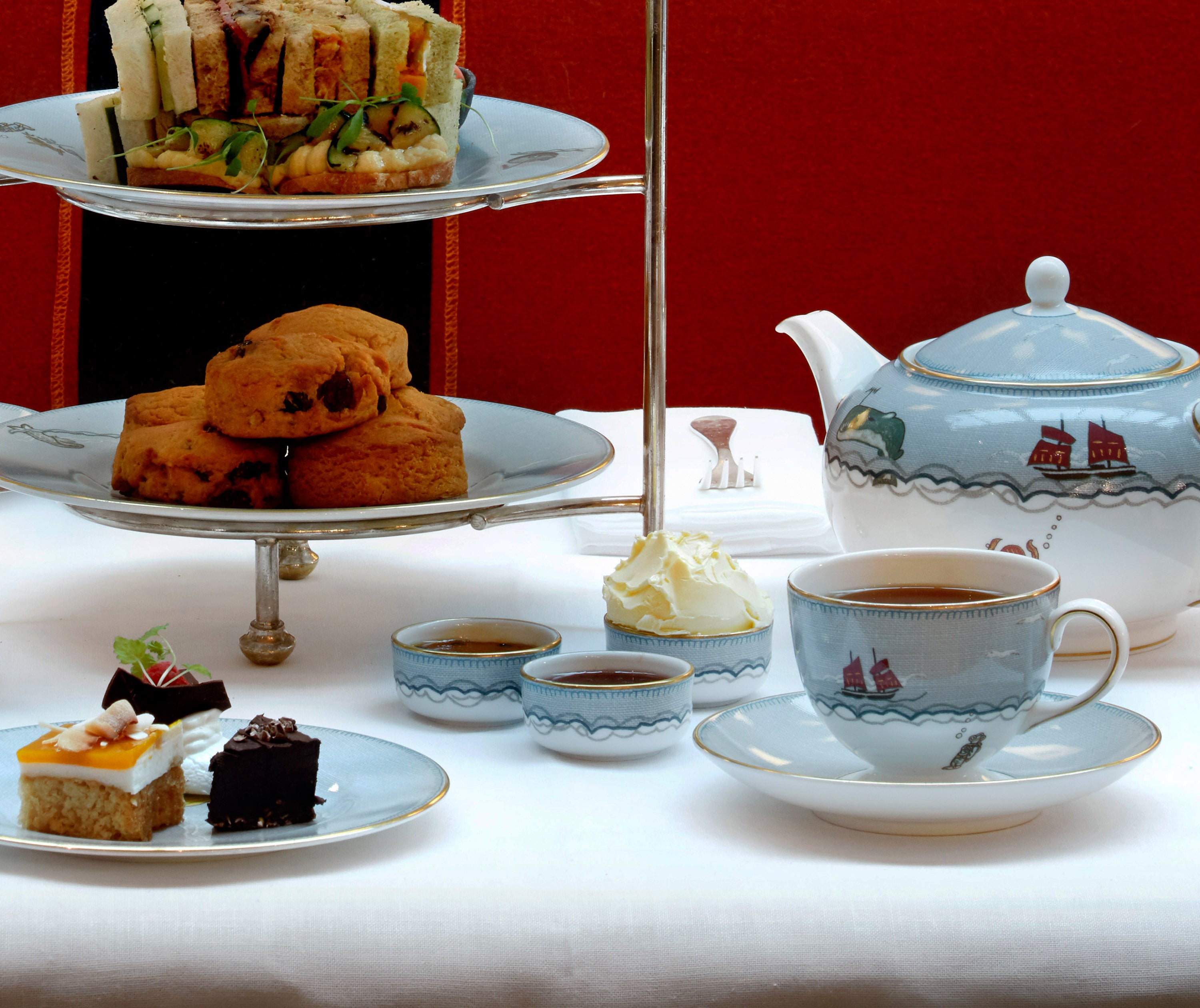 Sailors Farewell afternoon tea set up with a close up of 3 sailors ramekins with jam and cream inside