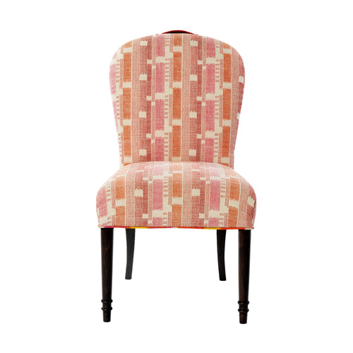 An elegant balloon back chair with a pink and ozone lemon upholstery, featuring a pink leather top handle and wenge wooden legs that curve outward at the back.
