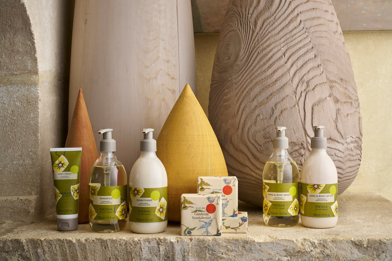 A lifestyle image of a range of Hand soaps, body washes and shampoo and conditioner on a stone shelf