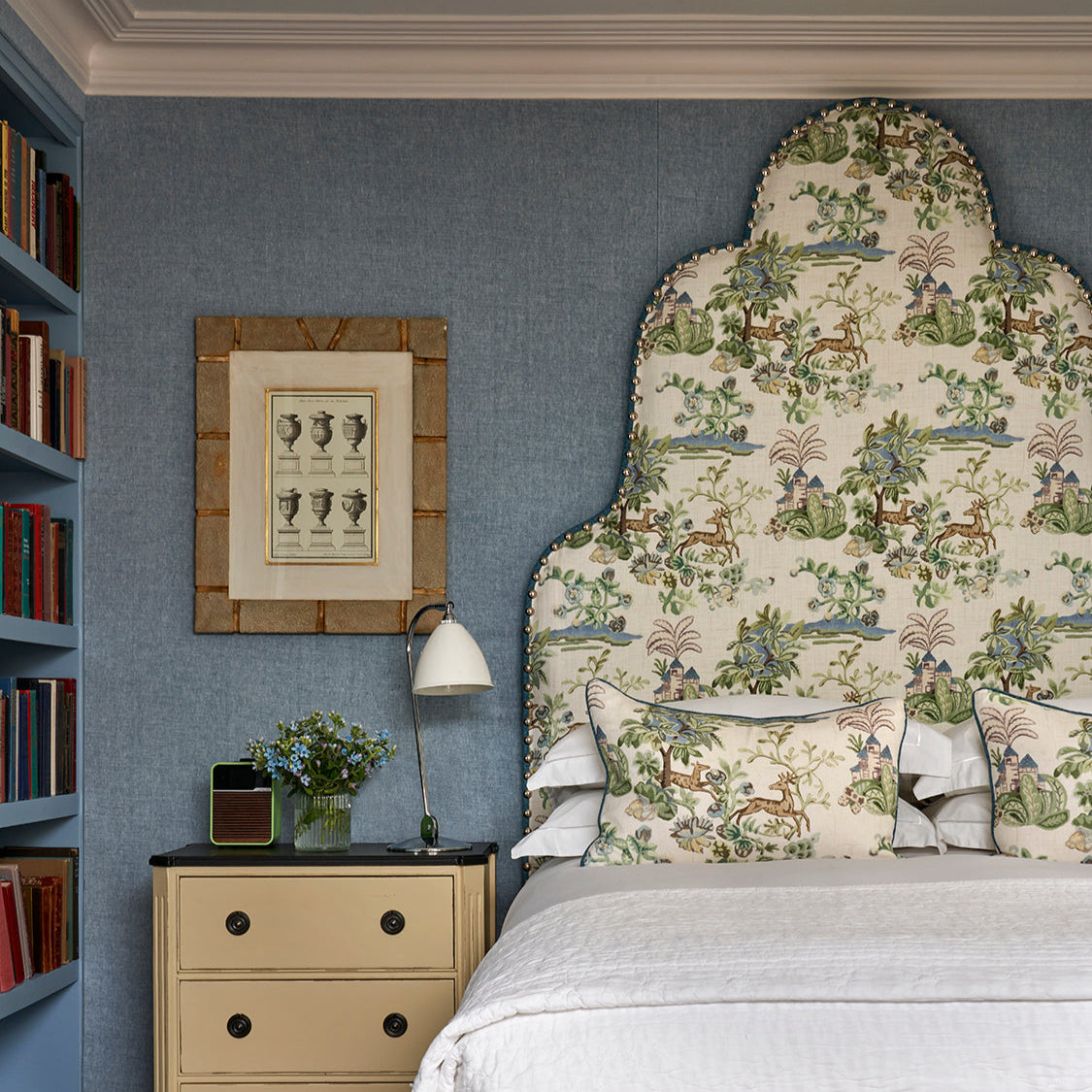 Arched headboard upholstered in Kit Kemp fabric design 'Knights Tale’ for GP and J Baker, customisable for bespoke orders. Photographed in Firmdale hotel bedroom.