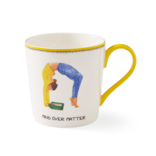 This yellow and white doodle mug features a sketch of a woman in a yoga pose, ( dressed in yellow and blue, whilst reading a green book perfectly illustrates the Mind over Matter tag-line, is trimmed with a yellow lip, and handle.