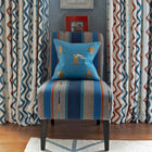 Buzz Off cushion in blue offsets the Bunty upholstered chair and rick rack fabric curtains, part of the interior design scheme by Kit Kemp