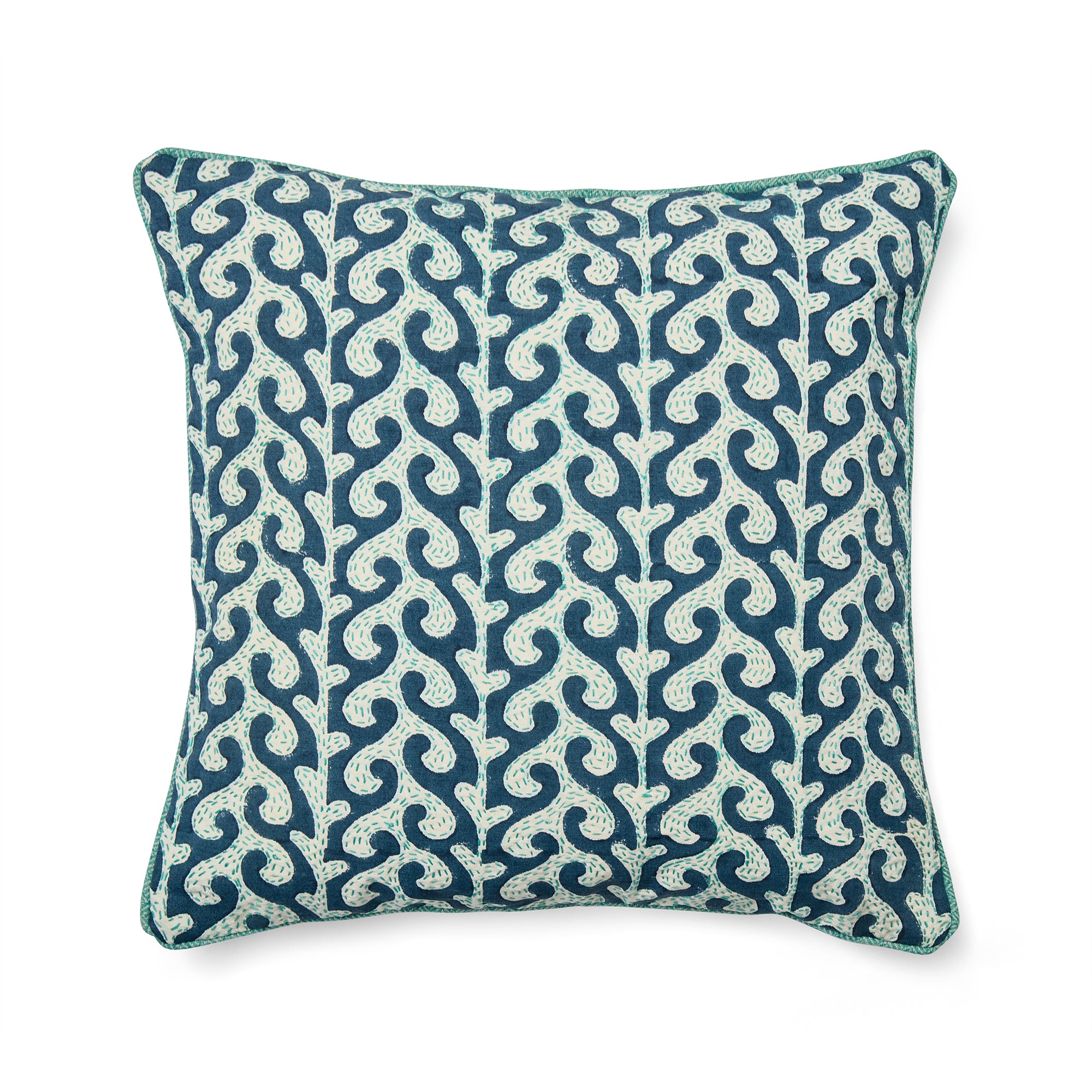 A Kit Kemp Design Studio decorative cushion featuring a hand-block printed blue wave motif. The organic wave pattern is layered with intricate white Kantha hand-embroidery, adding a rich tactile texture. The design is finished with a vibrant turquoise piped edge, creating a playful and luxurious nautical aesthetic.