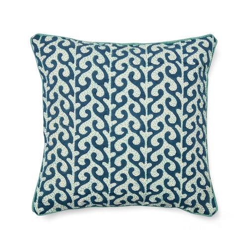 A Kit Kemp Design Studio decorative cushion featuring a hand-block printed blue wave motif. The organic wave pattern is layered with intricate white Kantha hand-embroidery, adding a rich tactile texture. The design is finished with a vibrant turquoise piped edge, creating a playful and luxurious nautical aesthetic.