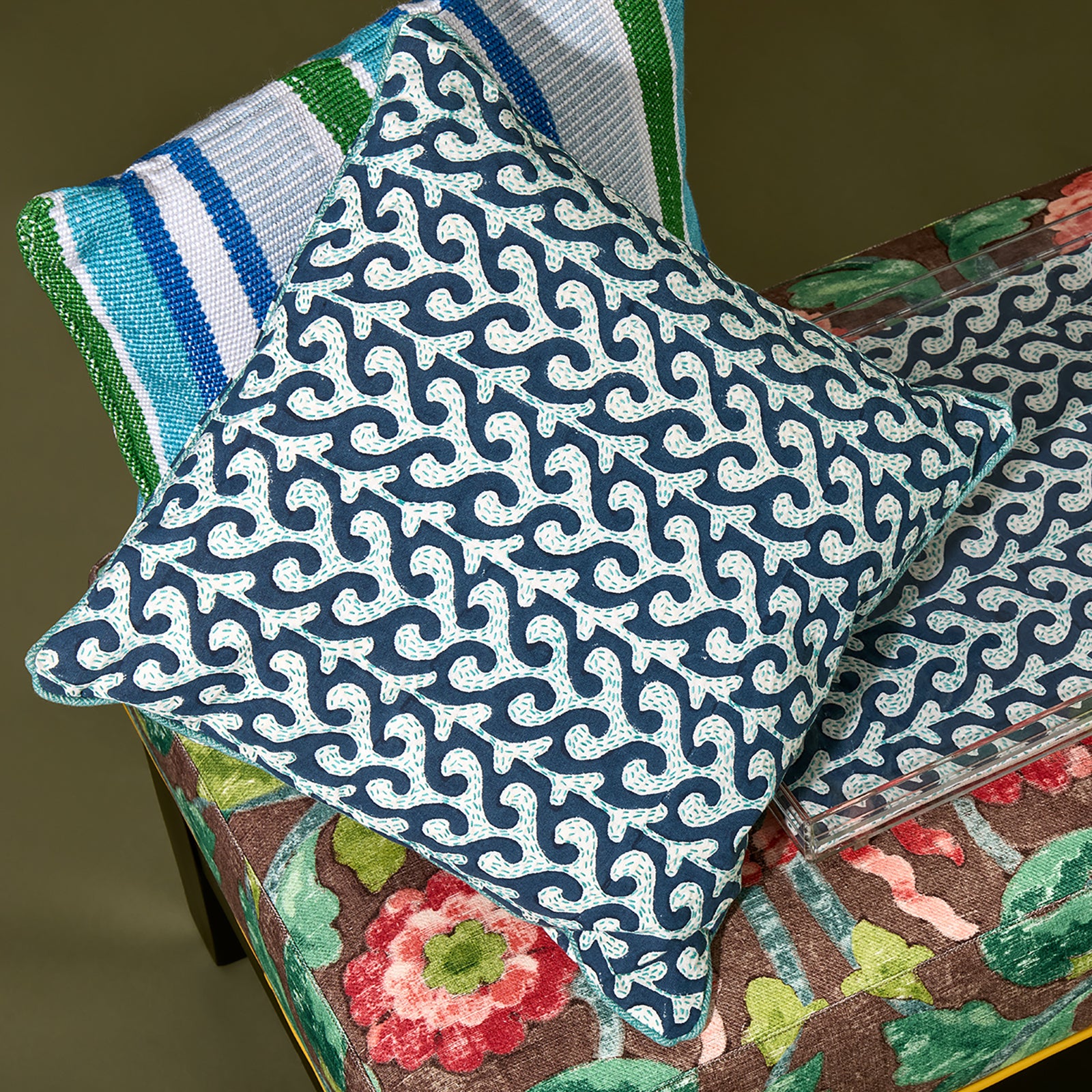 Artisan-made Kit Kemp cushion in a blue and white wave print. This piece showcases traditional hand-block printing and detailed Kantha hand-stitching for a unique, textured finish. Framed with a bright turquoise piping, it offers a sophisticated yet playful take on nautical interior design.