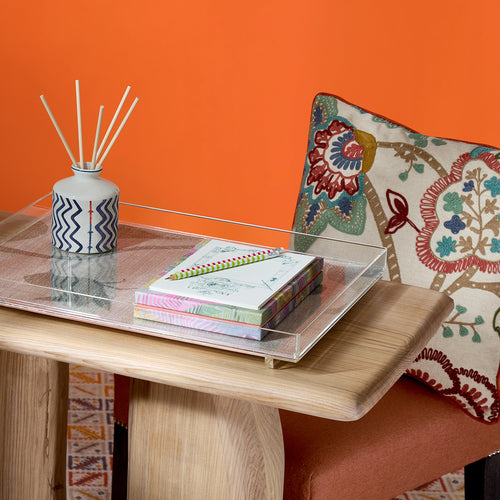 'Bohemian Garden' cushion with handle chair and flintstone console by Kit Kemp, showcasing its decorative versatility in a luxury interior. The rich, floral embroidery offers a timeless English country feel, while its reversible ruby side allows for dramatic room styling.