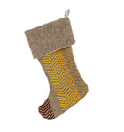 A stylish Christmas stocking in a neutral wool material, featuring the embroidered Bookend design with a bold, yellow geometric zigzag pattern. Sustainable and handmade, it's a festive gifting and a memorable holiday keepsake. 