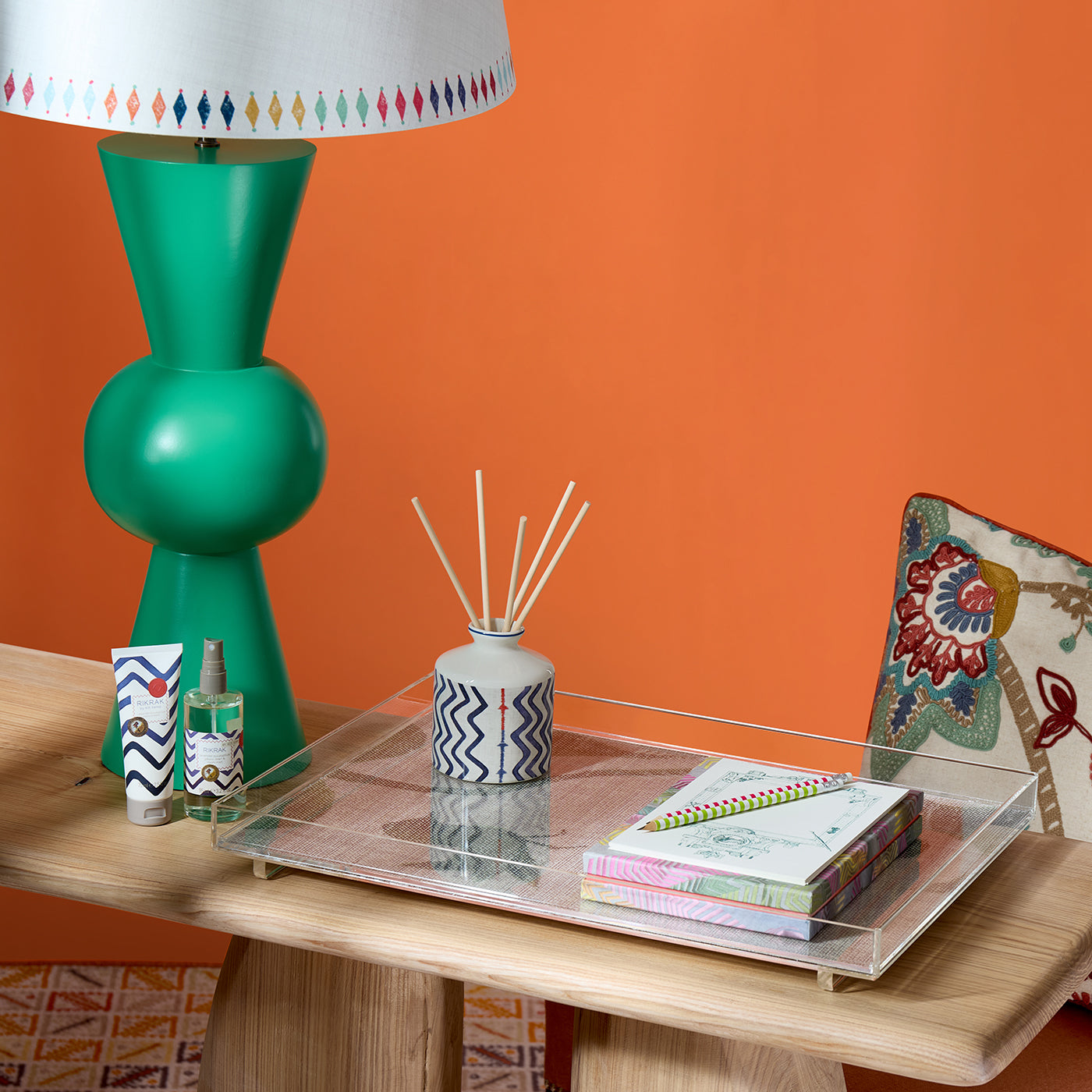 Green Bow Lamp paired with Diamond Lampshade in collaboration with Studio Zef, curated on Flintstone console, shown with Kit Kemp's room fragrances in Lavender and Eucalyptus, Monsoon design tray, and rich hand cream, for a luxurious home office style.