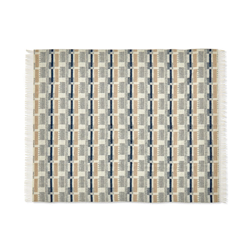 A luxurious 100% Merino wool throw in Blue/Natural. This design, based on a Kit Kemp fabric for Christopher Farr, features an intricate geometric block pattern in sophisticated, calming colours, beautifully made in England.