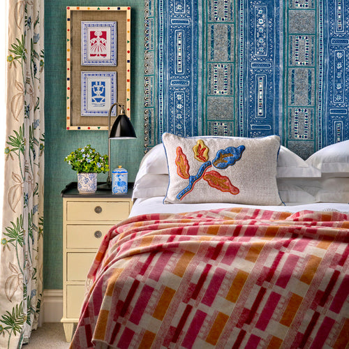 Soho hotel room design with striking brick weave throw in orange and pink, inspired by Kit Kemp's signature fabric design. Add a touch of luxury and softness with this 100% merino throw.