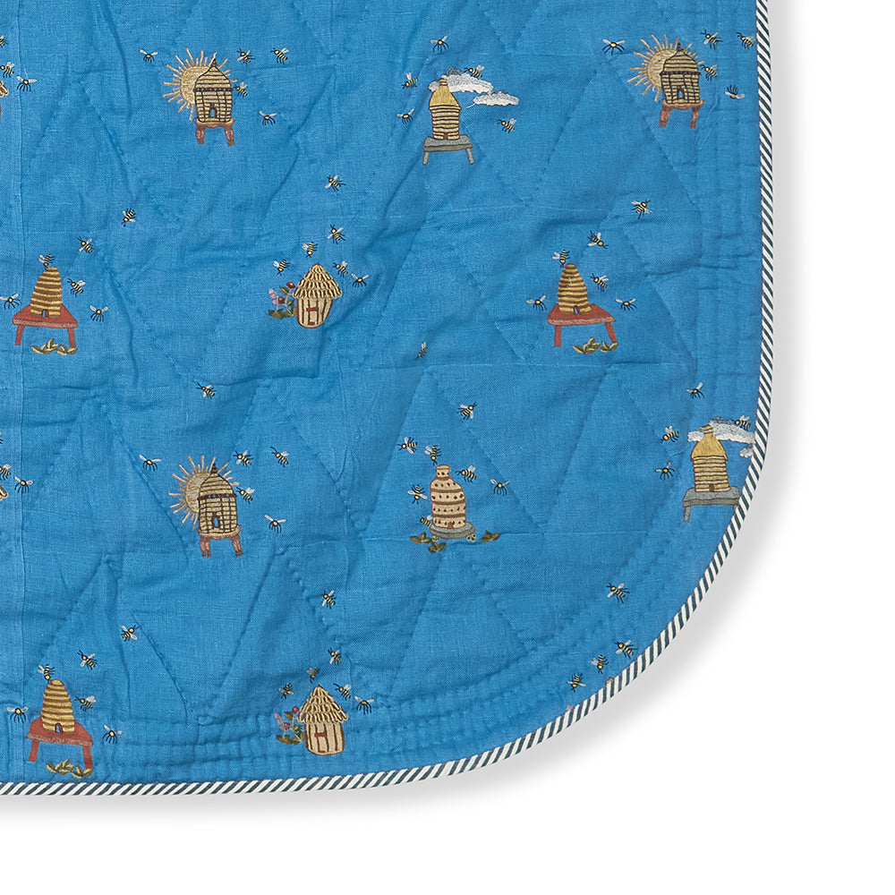 Close-up of the quilted linen of the Buzz Off Quilted Bedspread in Blue, highlighting the refined stitching, luxurious texture and exceptional craftsmanship by Kit Kemp for Chelsea Textiles.