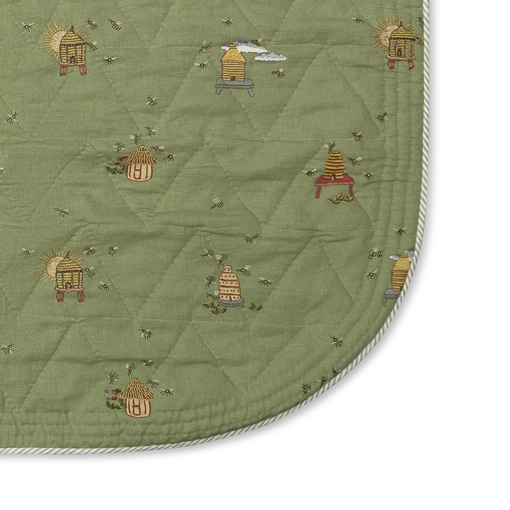 Close-up of the quilted linen on the Buzz Off Quilted Bedspread in Green, highlighting the refined stitching, luxurious texture and exceptional craftsmanship by Kit Kemp for Chelsea Textiles.