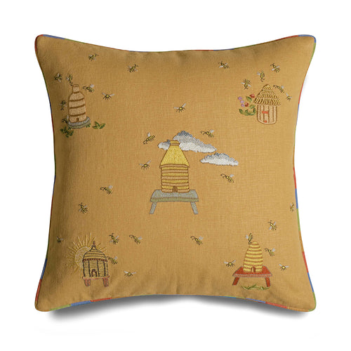 Kit Kemp for the Chelsea Textiles cushion with embroidered bee hives and bees on a yellow, edged in rainbow piping. 