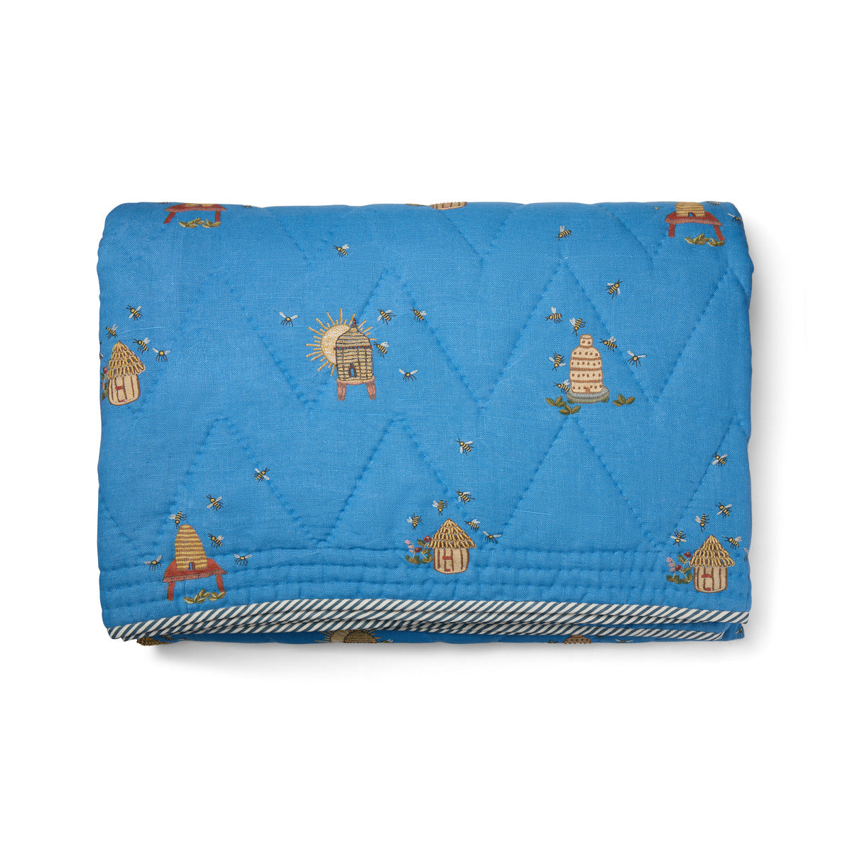Buzz Off Quilted Bedspread in Blue from the Weekend Collection by Kit Kemp - Chelsea Textiles, crafted from quilted linen with embroidered bee and floral motifs and a beautifully bound finish.