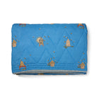 Buzz Off Quilted Bedspread in Blue from the Weekend Collection by Kit Kemp - Chelsea Textiles, crafted from quilted linen with embroidered bee and floral motifs and a beautifully bound finish.