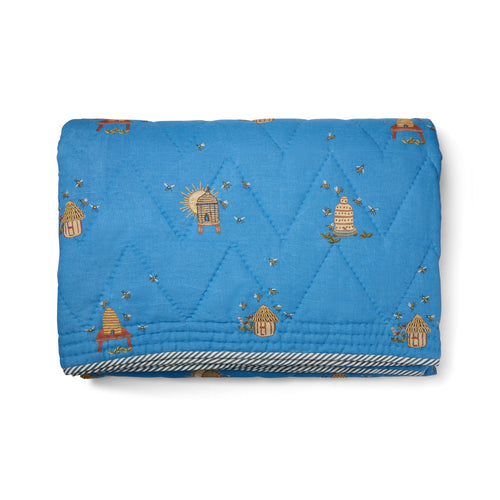 Buzz Off Quilted Bedspread in Blue from the Weekend Collection by Kit Kemp - Chelsea Textiles, crafted from quilted linen with embroidered bee and floral motifs and a beautifully bound finish.