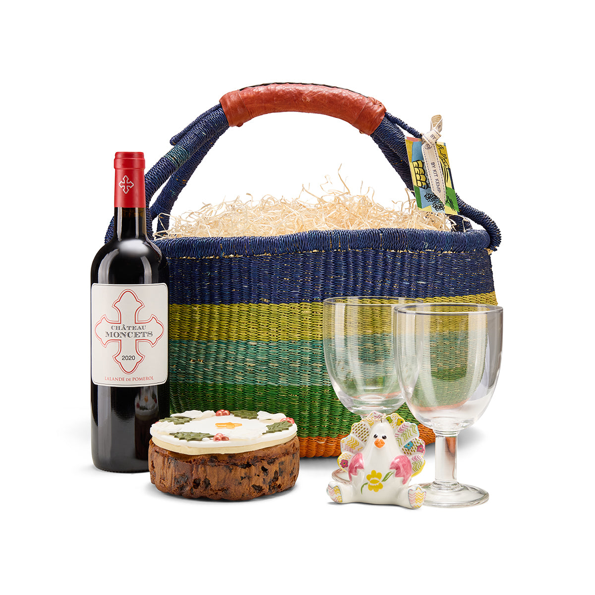 Christmas and festive season gift set with red wine, iced fruit cake, two wine glasses, and porcelain turkey character ornament.