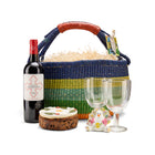 Christmas and festive season gift set with red wine, iced fruit cake, two wine glasses, and porcelain turkey character ornament.