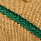 Kit Kemp Design Studio 45cm (18in) cushion in mustard yellow with multicoloured embroidered stripes. The rustic texture of the Élitis fabric is paired with vibrant embroidery and a contrasting blue piped border, creating a playful home accessory.