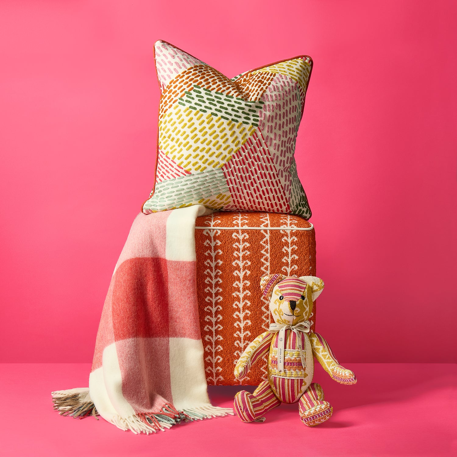 Checkerberry throw pairs perfectly with Kit Kemp's vibrant Running Stitch cushion, and Little Weed stool, with the orange, terracotta, and warm yellow tones to bring warmth and accent colour to any interior.