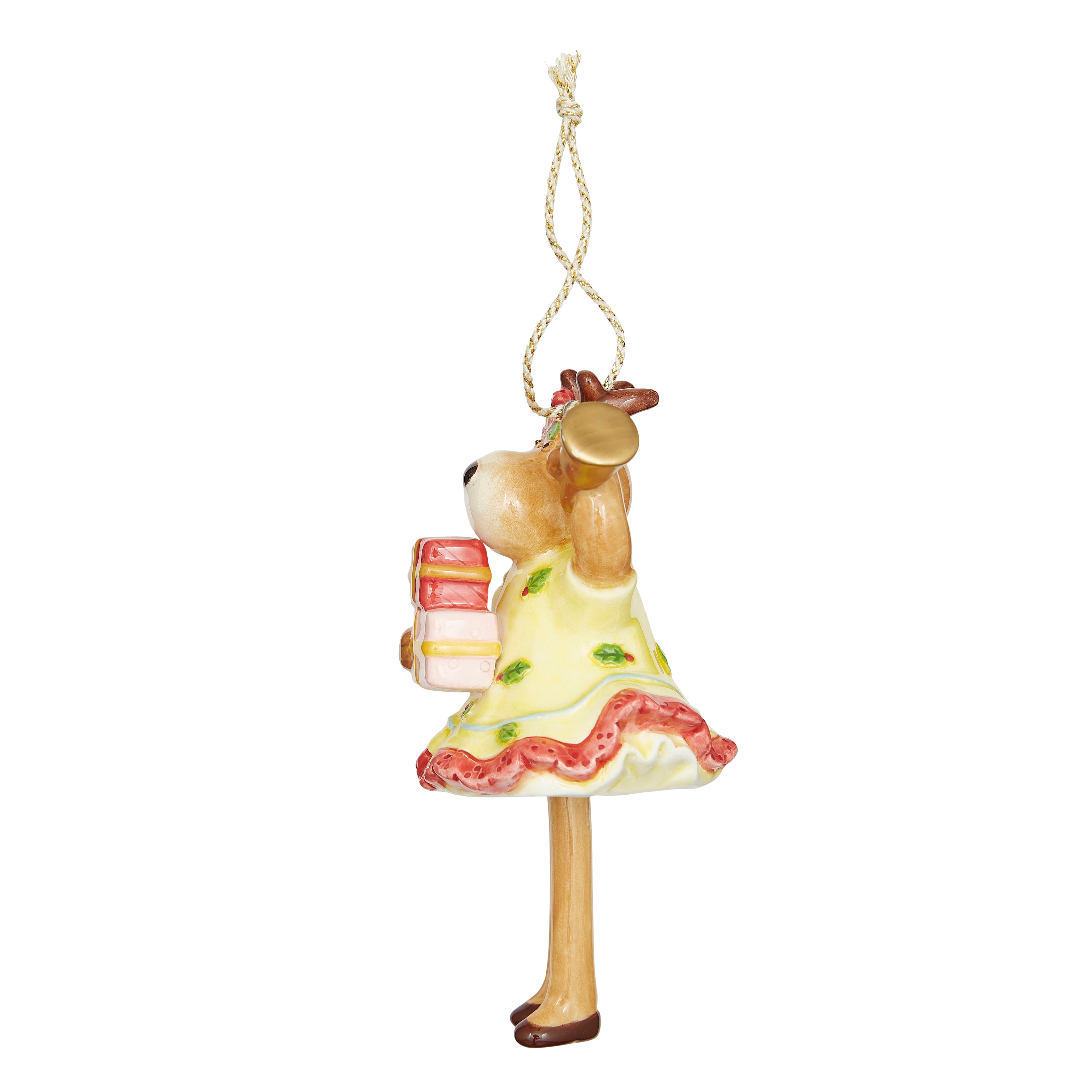 Festive fine china Christmas Bell Reindeer Ornament. Features a reindeer holding a bell and a present, dressed in a patterned yellow skirt, with a red bow. The signature dangling legs make this a unique and whimsical tree decoration and a delightful gift.