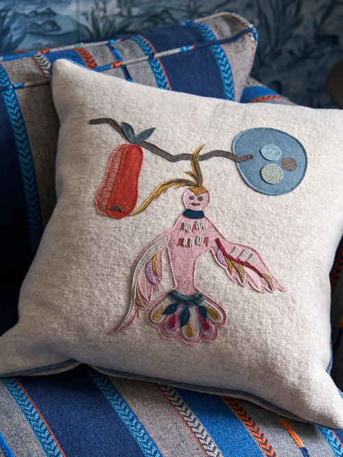 Cocktail Shaker cushion on Blue Bunty upholstered seat, combining folk references and stylish stripe designs.