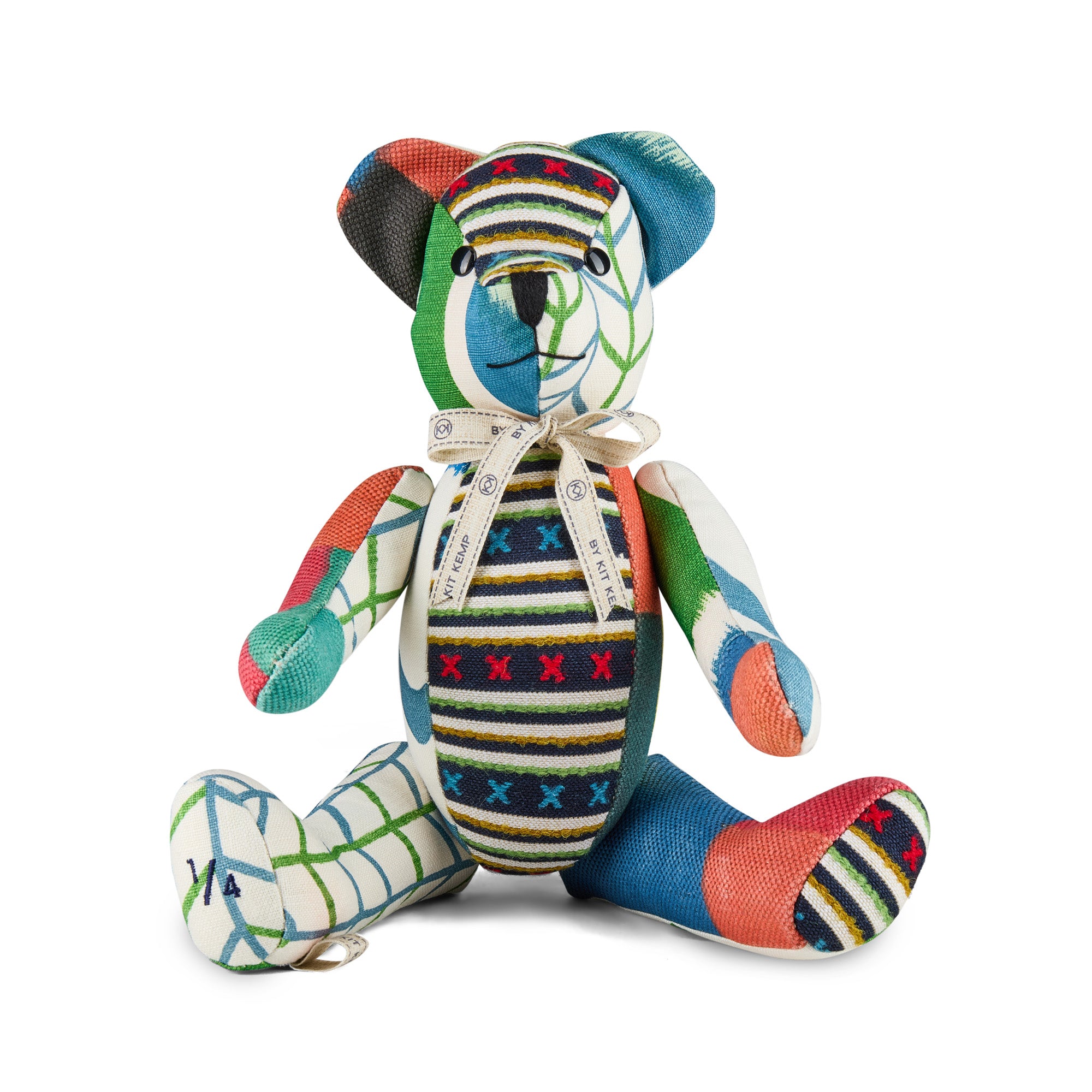Handmade Kit Kemp Willow Bear featuring a vibrant patchwork design in Zig Zag Berry, Ozone blue, and Criss Cross Indigo fabrics. The bear has a tall, slender silhouette with a whimsical, hand-stitched personality and a 'Kit Kemp' signature tag.