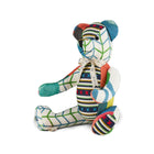 A one-of-a-kind Large Willow Bear from the Kit Kemp Patchwork Collection, handcrafted in the UK using repurposed fabric offcuts and recyclable filling. The bear showcases a mix of colourful geometric patterns in Kit Kemp's iconic fabrics with tones of pink, blue, green and navy.