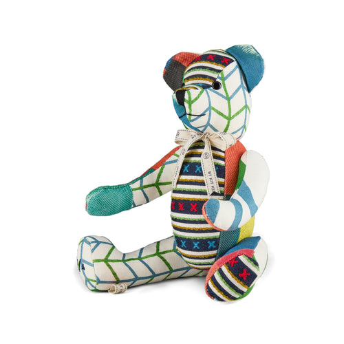 A one-of-a-kind Large Willow Bear from the Kit Kemp Patchwork Collection, handcrafted in the UK using repurposed fabric offcuts and recyclable filling. The bear showcases a mix of colourful geometric patterns in Kit Kemp's iconic fabrics with tones of pink, blue, green and navy.