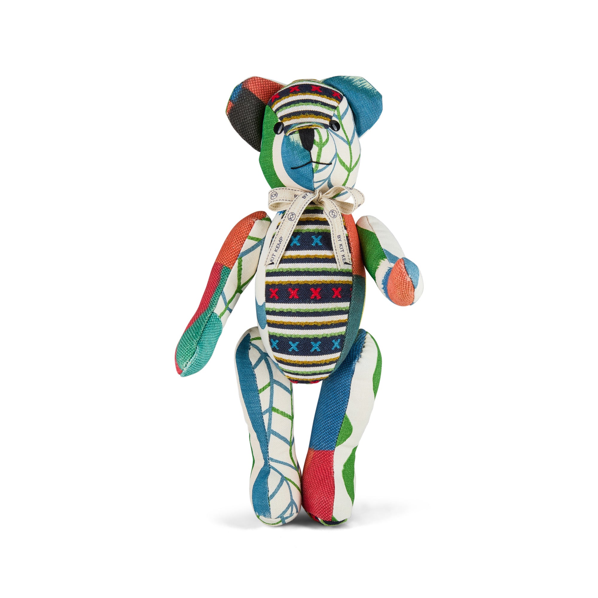 Special edition Willow Bear from the Kit Kemp Patchwork Collection, shown in a seated position against a white background. This artisanal teddy bear features a vibrant mix of patterned fabric offcuts, button eyes, and fully articulated limbs, highlighting its unique 'one-of-a-kind' handmade construction.