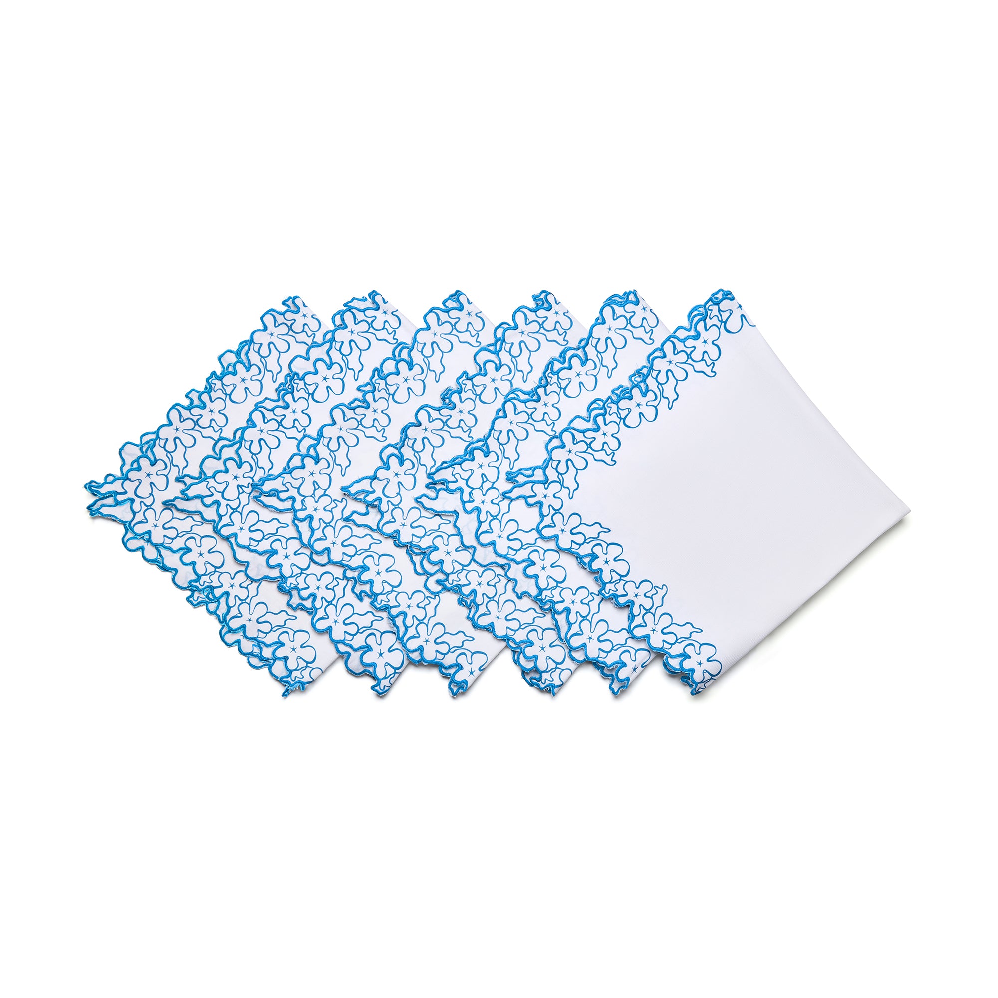 Handmade in India, these 50cm x 50cm (20in x 20in) white cotton napkins showcase a signature blue floral petal border with intricate cutwork. Their versatile design is crafted to complement both everyday dining and special occasions, offering a high-quality artisanal touch to the Kit Kemp collection.