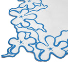 This white cotton tablecloth by Kit Kemp featuring a signature deep blue embroidered flower border and handmade cutwork detailing from India. Each one is handmade and exclusively sold at Shop Kit Kemp.