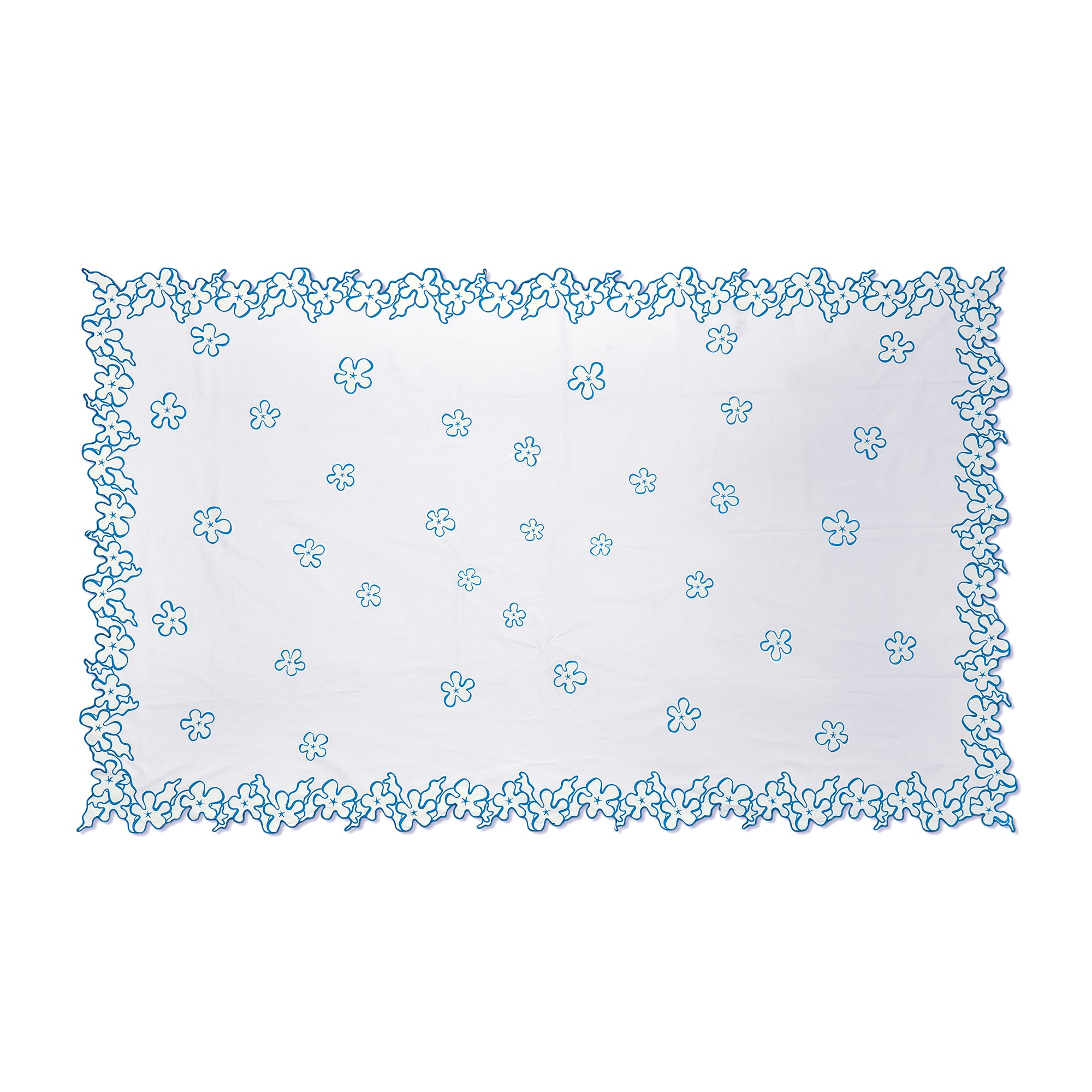 White cotton Kit Kemp tablecloth featuring a vibrant deep blue embroidered flower border with intricate cutwork edging. This handmade in India piece measures 140cm by 240cm (approximately 55in by 94in. The understated elegance makes it perfect for both special occasions and daily dining, especially when paired with Petal Cutout napkins and Sailor's Farewell tableware.