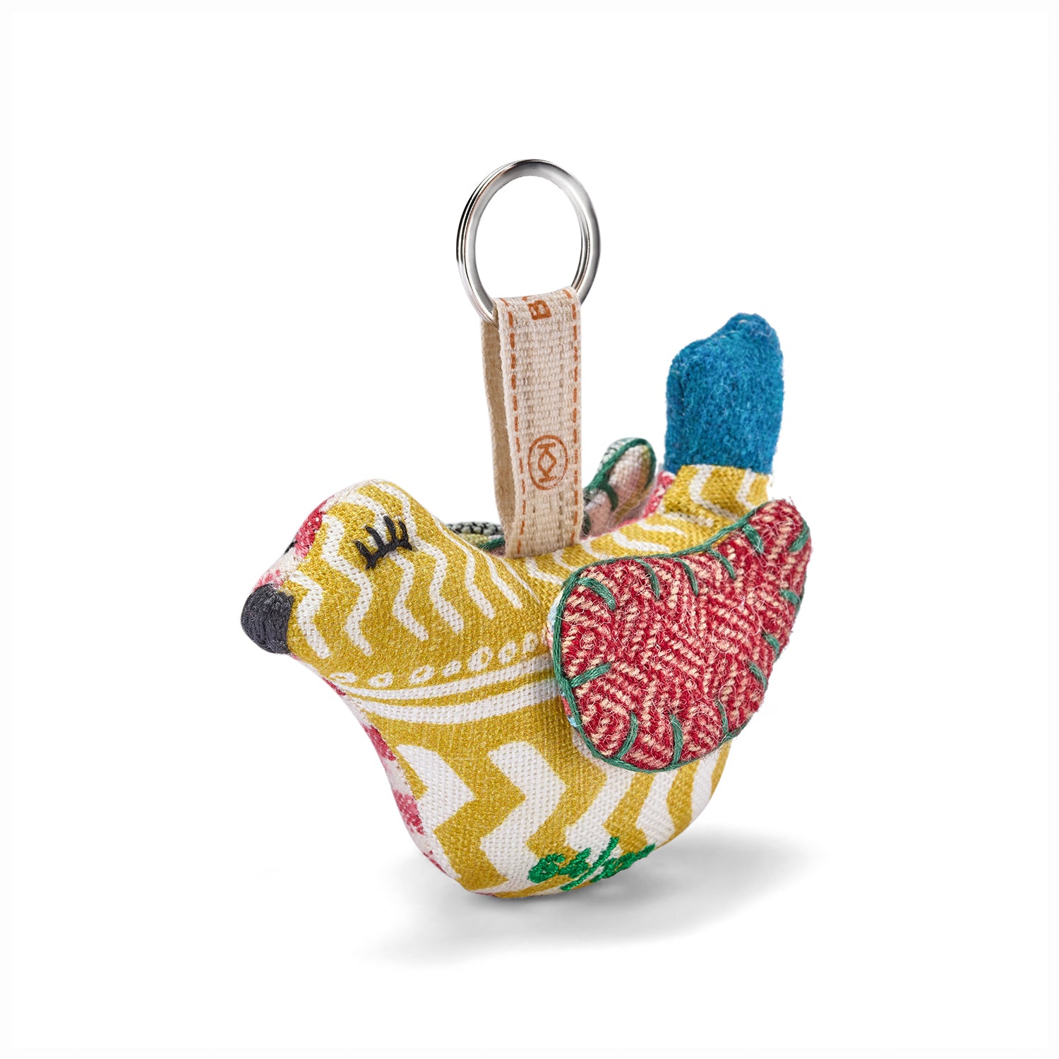 Colourful fabric keychain shaped like a dove bird, made with upcycled fabrics from Kit Kemp Design Studio, it makes a sustainable gift.