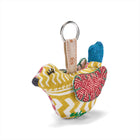 Colourful fabric keychain shaped like a dove bird, made with upcycled fabrics from Kit Kemp Design Studio, it makes a sustainable gift.