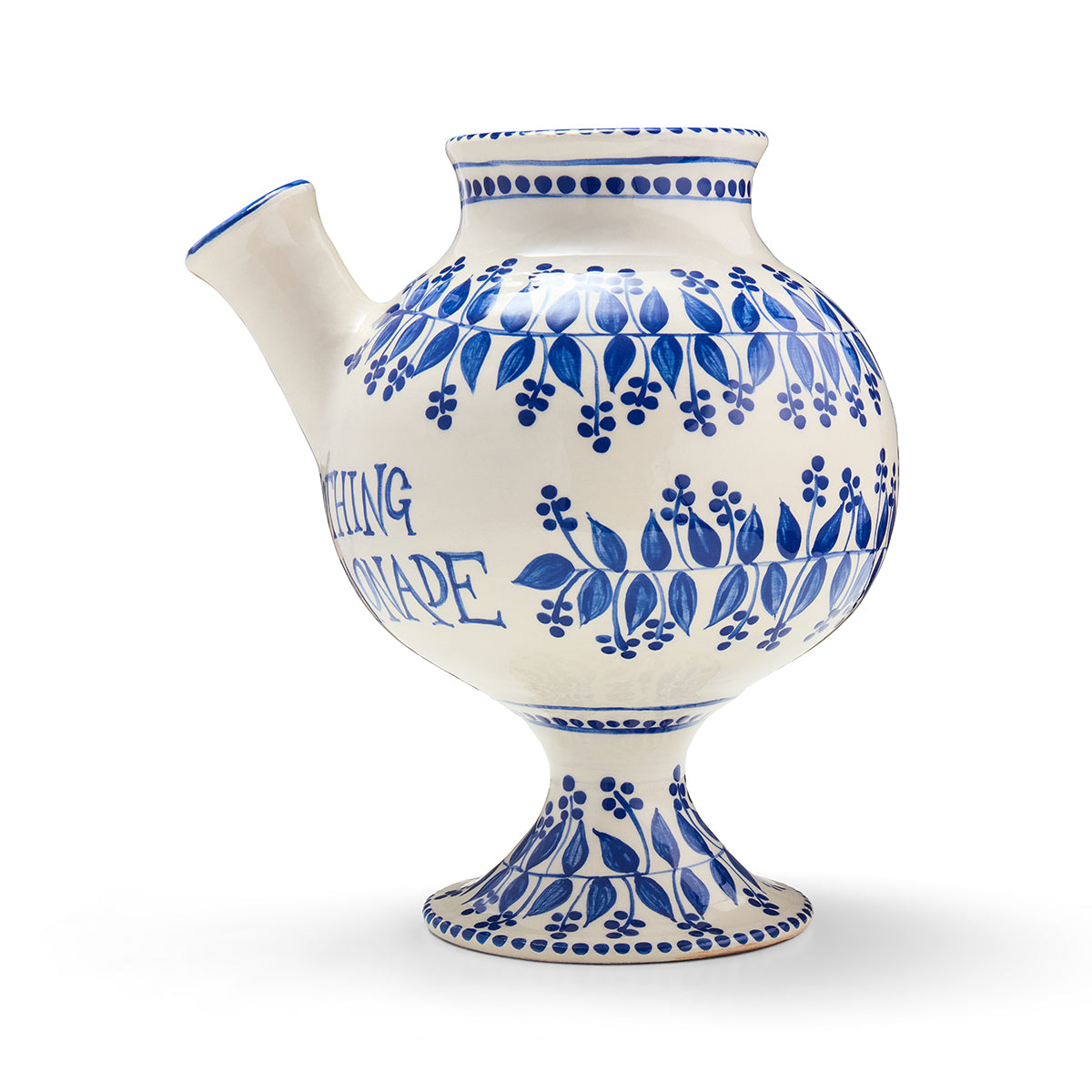 Syrup jug side, with distinctive spout and footed base detail. Rounded body is decorated with text and flora designs. 