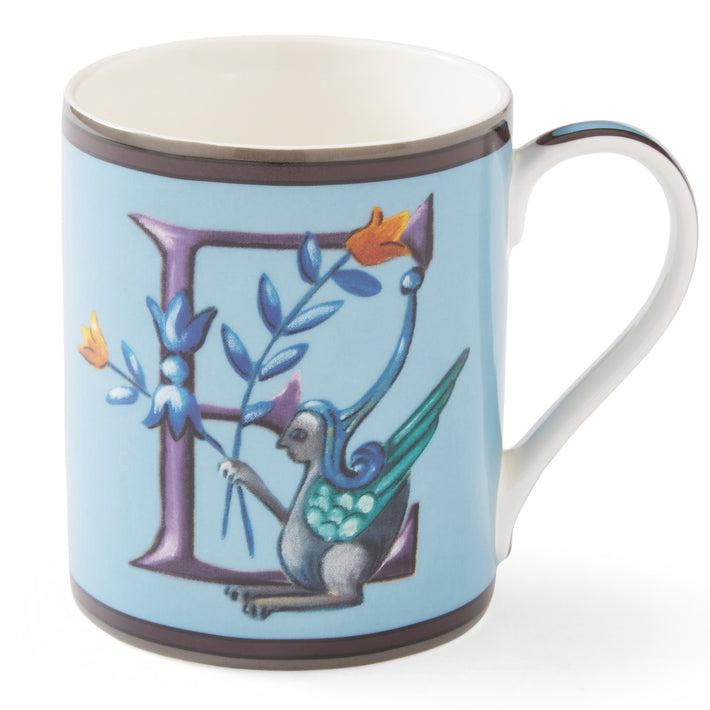 The purple e on this pale blue mug forms a decorative background to the mythical winged creature, with its blue and yellow corn-like floral posy.