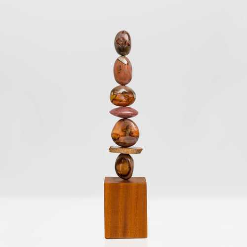 Earth's Heart totem is entirely unique and made from the richly coloured and deeply patterned Polychrome Jasper with a slice of Petrified Wood near the base. All sitting on an Iroko wood base.