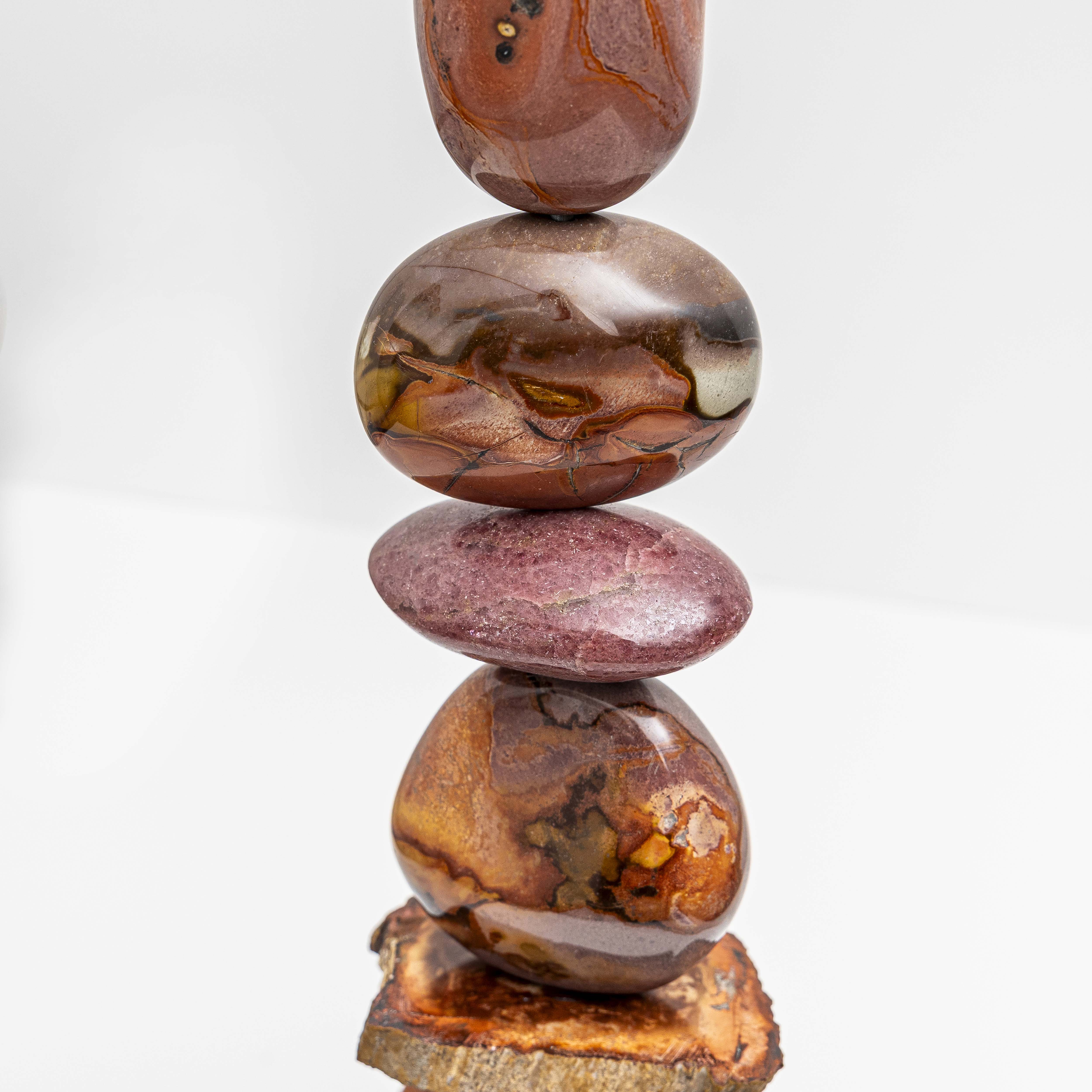 Artwork with deeply patterned Polychrome Jasper with a slice of Petrified Wood near the base. All sitting on an Iroko wood plinth. 
Artwork size H47cm W9cm D9 includes base.

