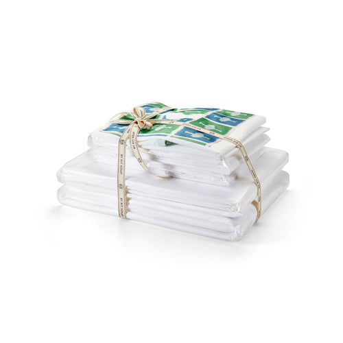 Luxury white Firmdale Hotels bed linen set featuring a 300 thread count cotton duvet cover and four Oxford pillowcases arranged on a perfectly made bed for a timelessly stylish hotel-at-home look.