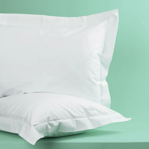 Detailed view of an Oxford pillowcase showing the classic wide fabric border and pristine white stitching, included as a set of four in King, Super King, and Emperor sizes.