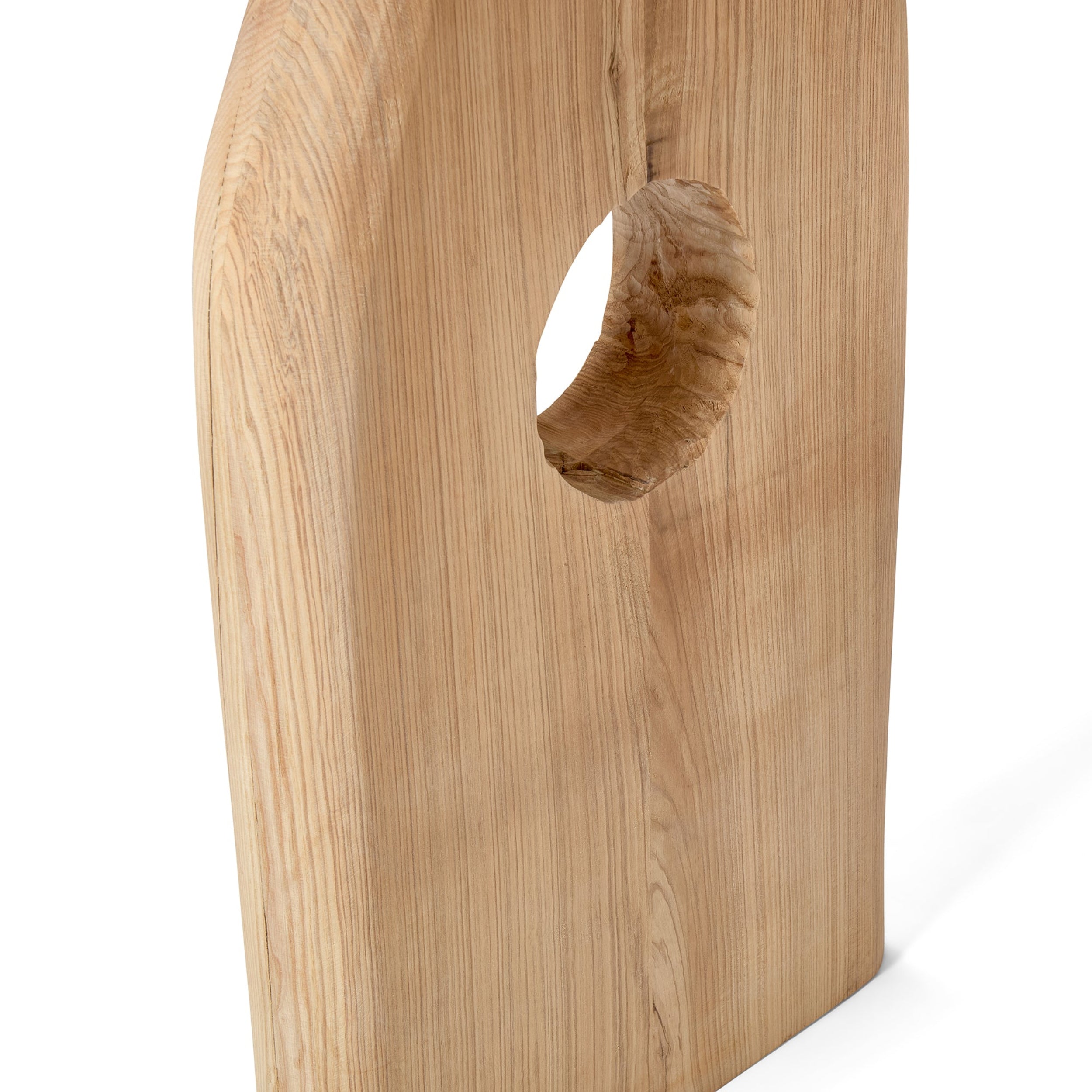 Wooden block with a circular hole on a white background