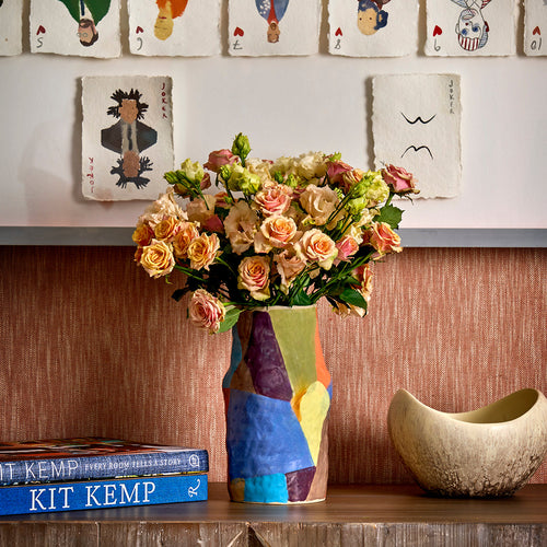 Ceramic flower vase designed by Valerie Gutton sitting on a console table 