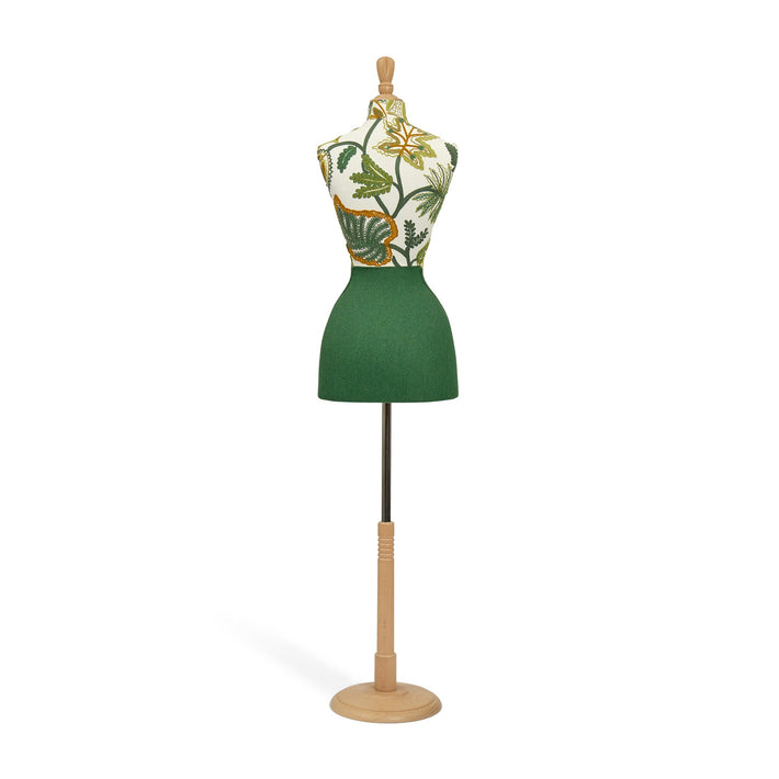 Mannequin wearing a green dress with floral pattern on a white background