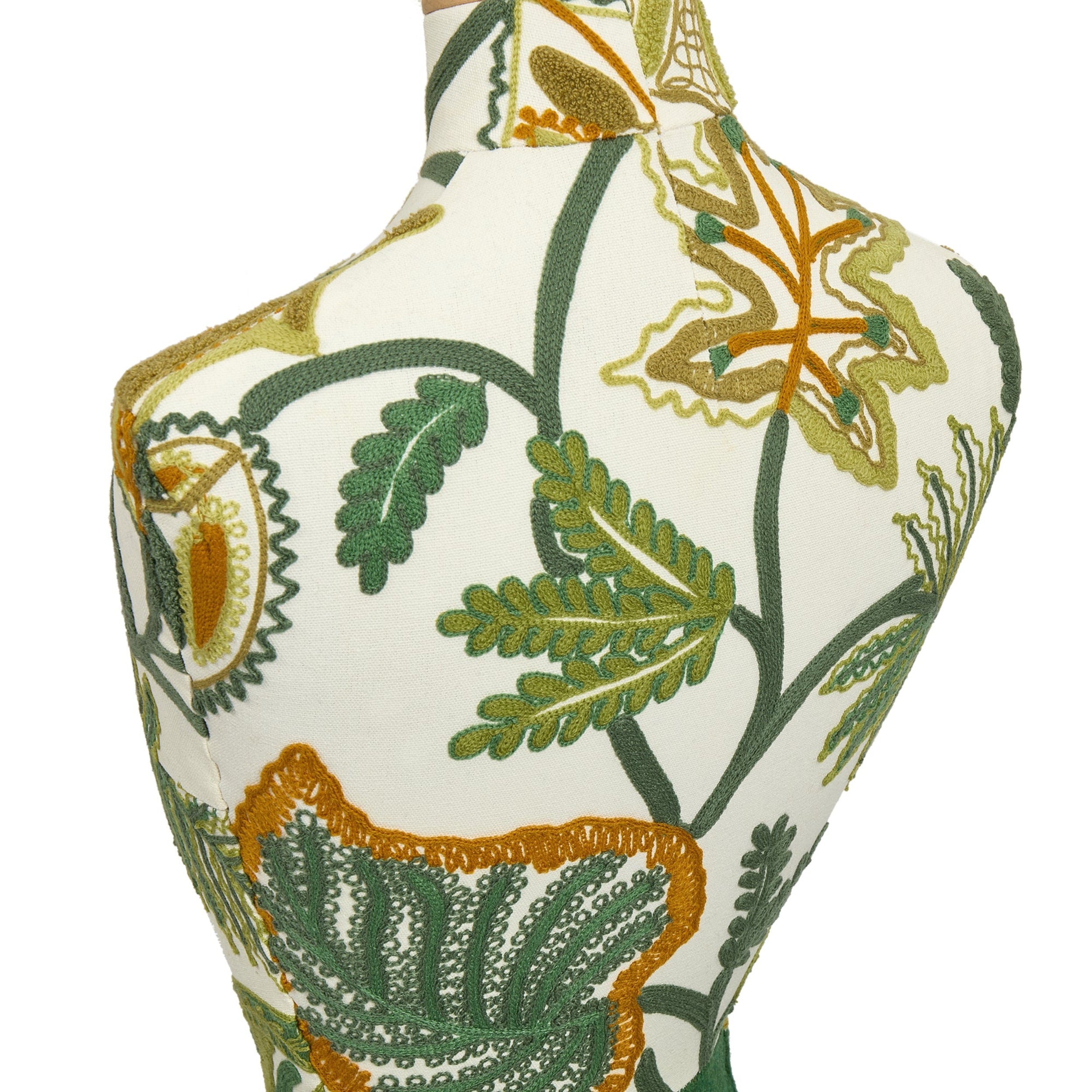 Decorative mannequin with green and gold leaf pattern on a white background
